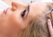 Plastic surgeon preparing for operation on woman hair